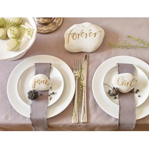 Décoration de table avec inscriptions dorées sur pierres, créées avec Edding Paintmarker.