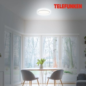 Plafonnier LED blanc Telefunken Slim Drip (18 W) dans un salon avec lumière indirecte.