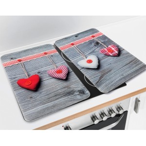 Set da 2 copripiano cottura universali Wenko Hearts su piano cottura, vetro, con motivo a cuore.
