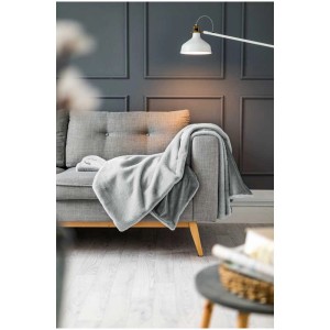 Coperta grigia Coste (130x180 cm) sul divano. Elegante accessorio per la casa per ore accoglienti.