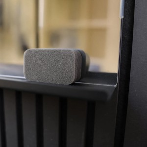 Dettaglio della lavagna magnetica nera Denpanels con mensola per pannello acustico.