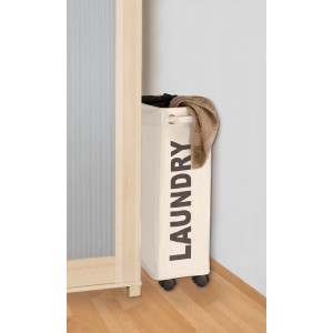 Cesto portabiancheria Wenko Corno beige stretto con ruote, 43 l, accanto a un mobile.
