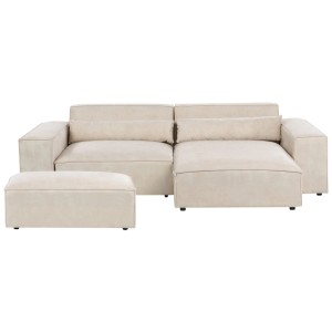 Canapé d'angle beige Beliani Hellnar en velours avec pouf et coussins.