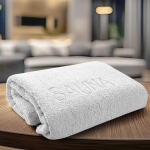 Serviette de sauna blanche en coton (70x200 cm) avec inscription "SAUNA".