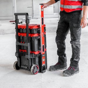 Supporto livella Einhell rosso-nero in plastica fissato a valigetta attrezzi E-Case con ruote. Livella rossa fissata.