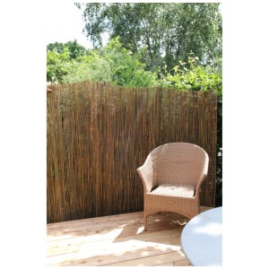 Pannello di recinzione in salice 90x300 cm come schermo naturale per la privacy in giardino, abbinato a una sedia in rattan.