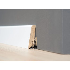 Egger Home Leistenclip zur Befestigung einer weißen Sockelleiste an einer grauen Wand.