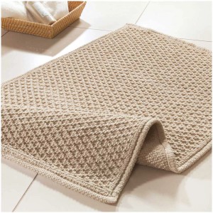 Tappeto bagno beige Spirella Perla (50x80 cm) in cotone con rivestimento antiscivolo.