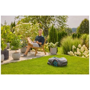 Robot tondeuse Gardena smart Sileno free sur pelouse, homme se détendant dans le jardin.