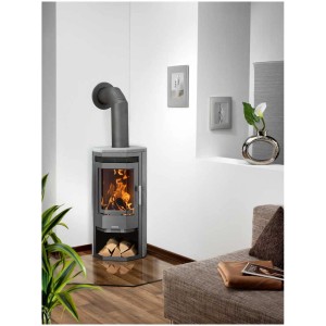 Poêle à bois Justus Usedom 5 en stéatite avec compartiment à bois et feu de cheminée dans le salon.