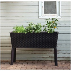 Jardinière surélevée en plastique anthracite avec système d'irrigation et plantes.